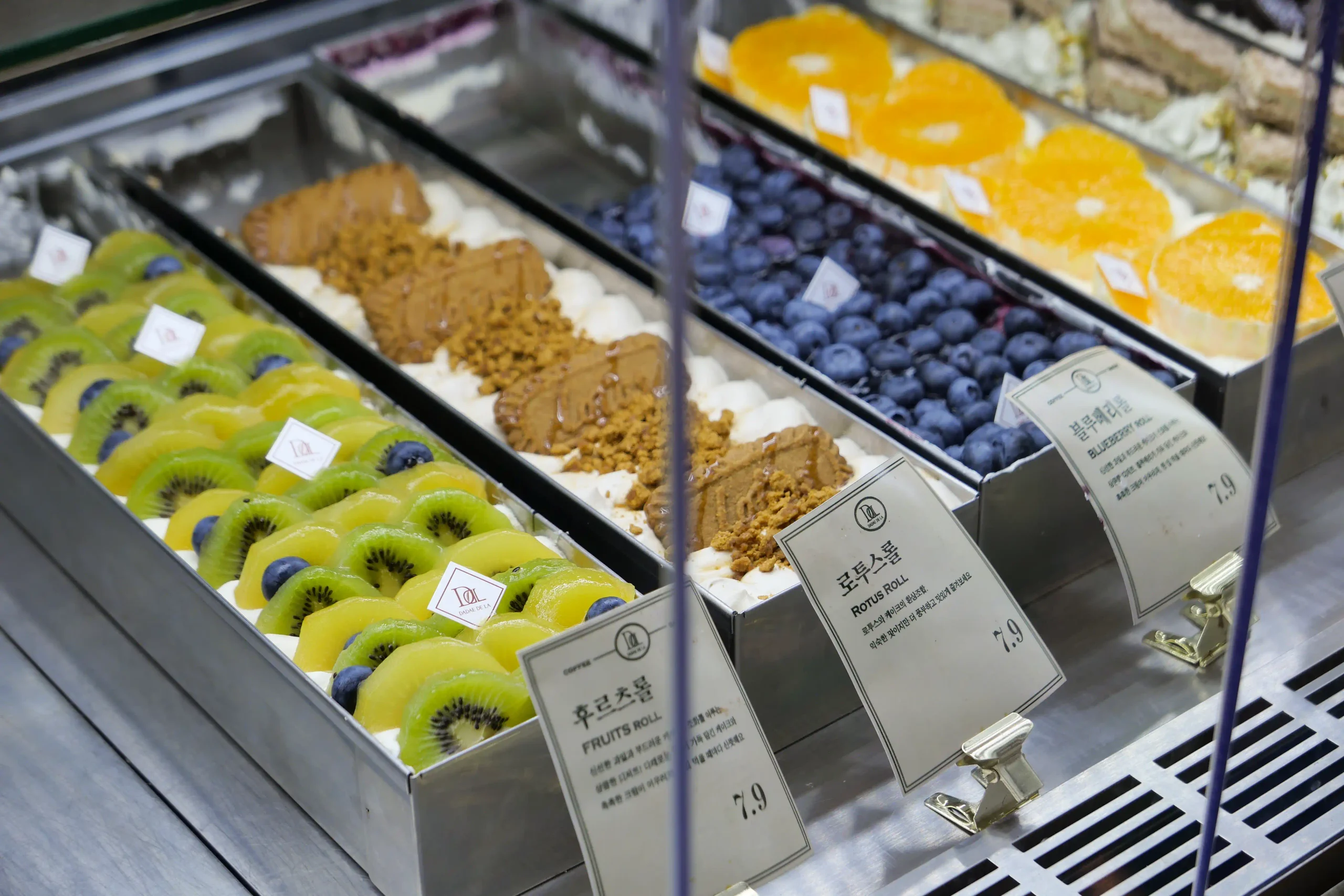 Assorted fruit and cream rolls displayed at DADAE DE LA cafe near Dadaepo Beach in Busan, South Korea